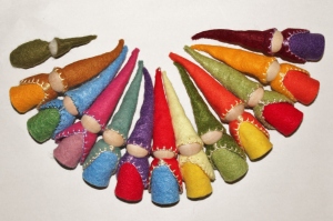 A dozen colourfully dressed Waldorf style gnomes, made with felt and wooden peg dolls, and a baby gnome made entirely from felt with a needle-felted wool head.